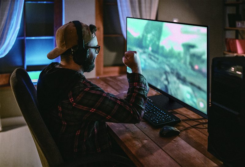 Teenager playing games on PC